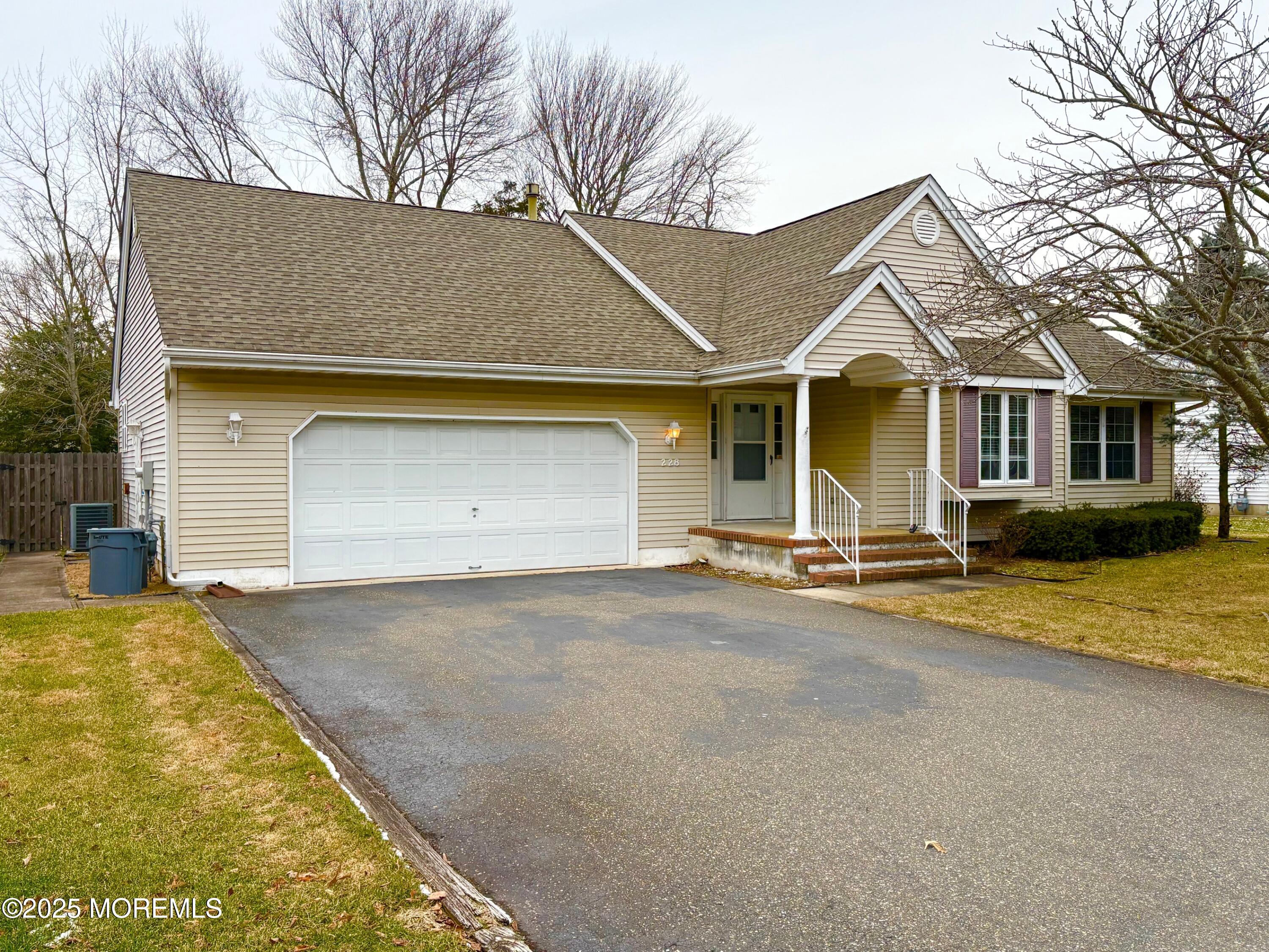 228 Sunset Drive Forked River, NJ 08731 - Photo 8 of 12 a front view of a house with a yard and garage