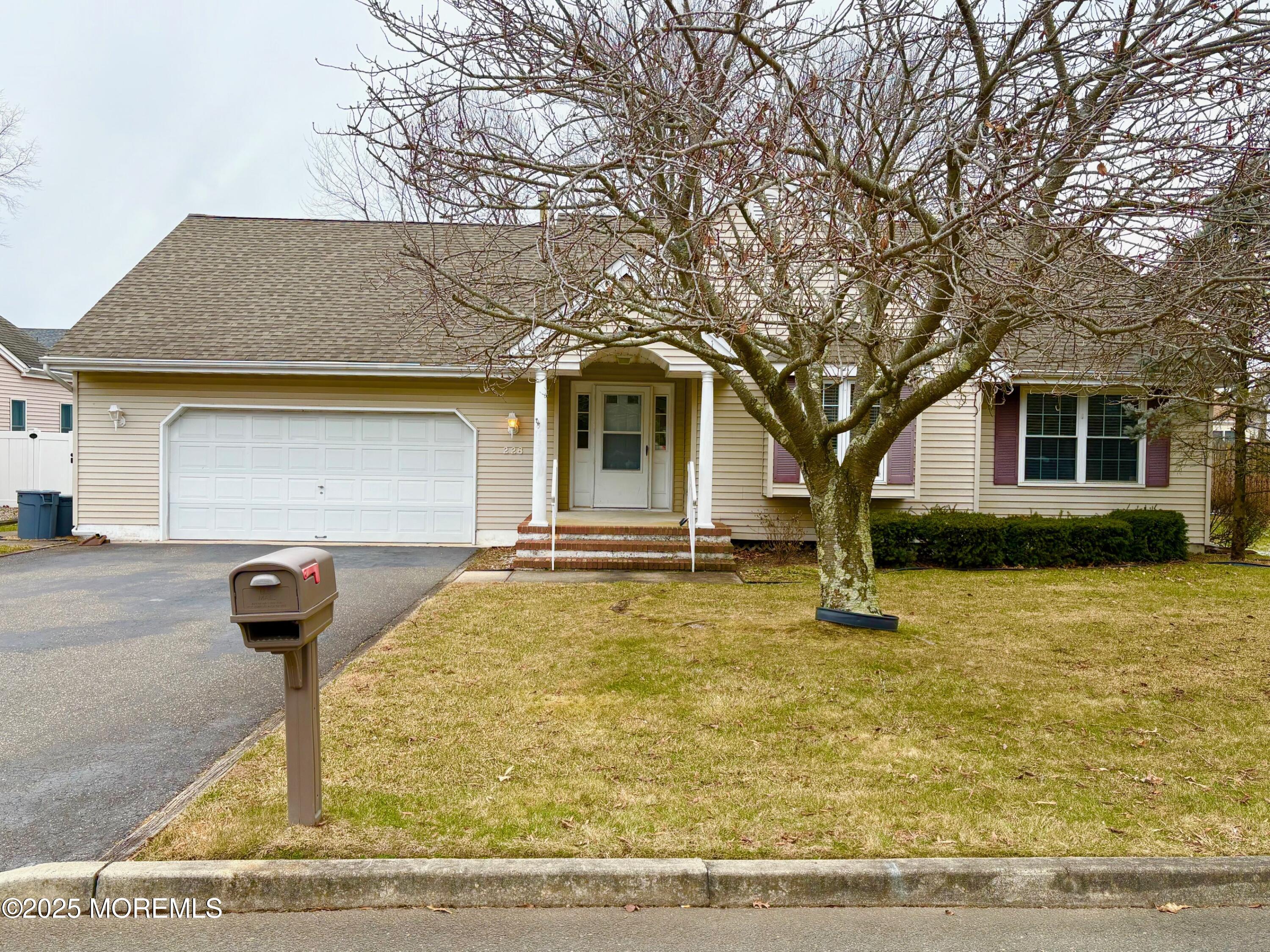 228 Sunset Drive Forked River, NJ 08731 - Photo 9 of 12 a front view of a house with garden