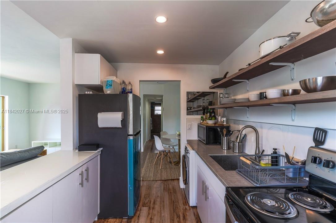 1234 Euclid Avenue, Unit 7 Miami Beach, FL 33139 - Photo 12 of 14 a kitchen with sink a stove and cabinets