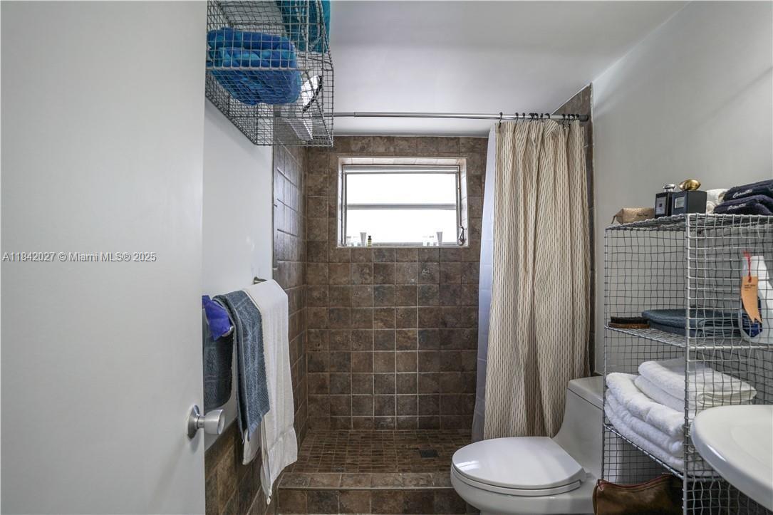1234 Euclid Avenue, Unit 7 Miami Beach, FL 33139 - Photo 7 of 14 a bathroom with a toilet and shower