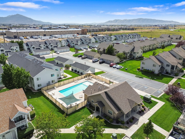 482 South 2500th West, Unit 2 Springville, UT 84663 - Photo 37 of 52 Community featuring a fenced outdoor swimming pool, adjacent clubhouse, and ample green space