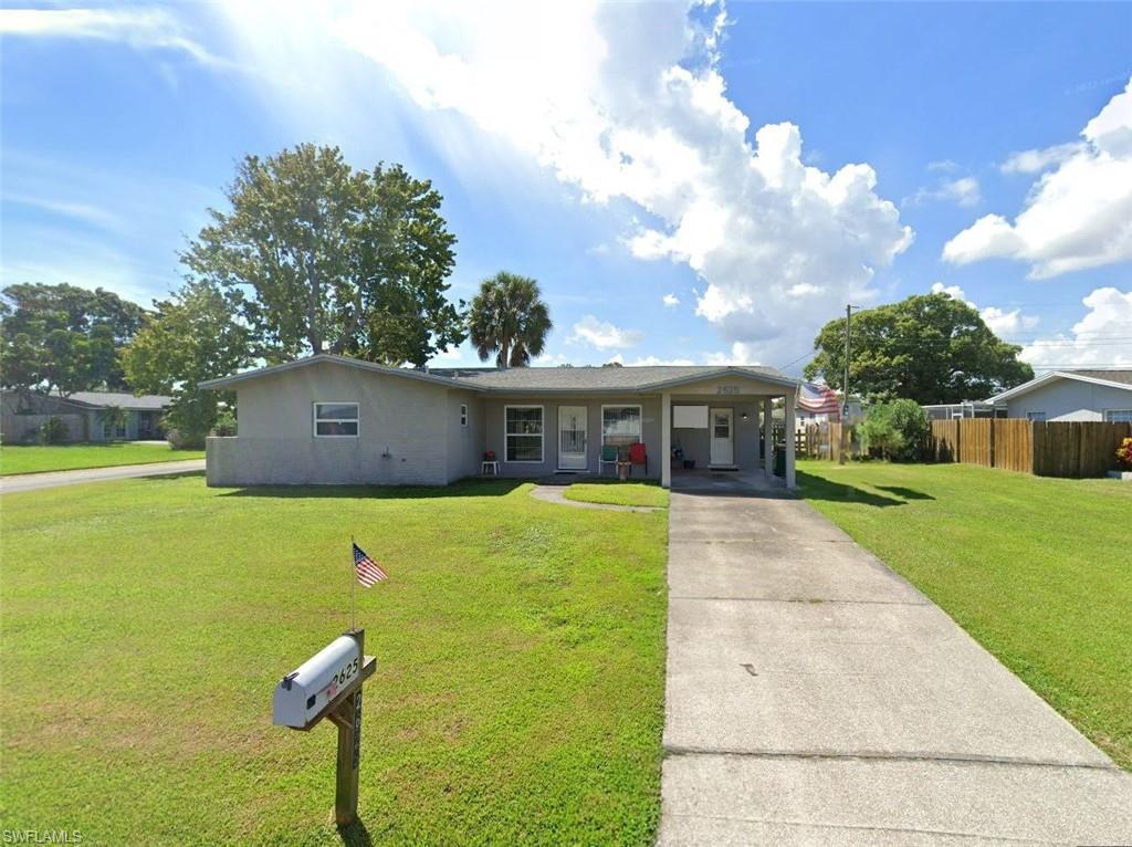 a front view of house with yard and trees