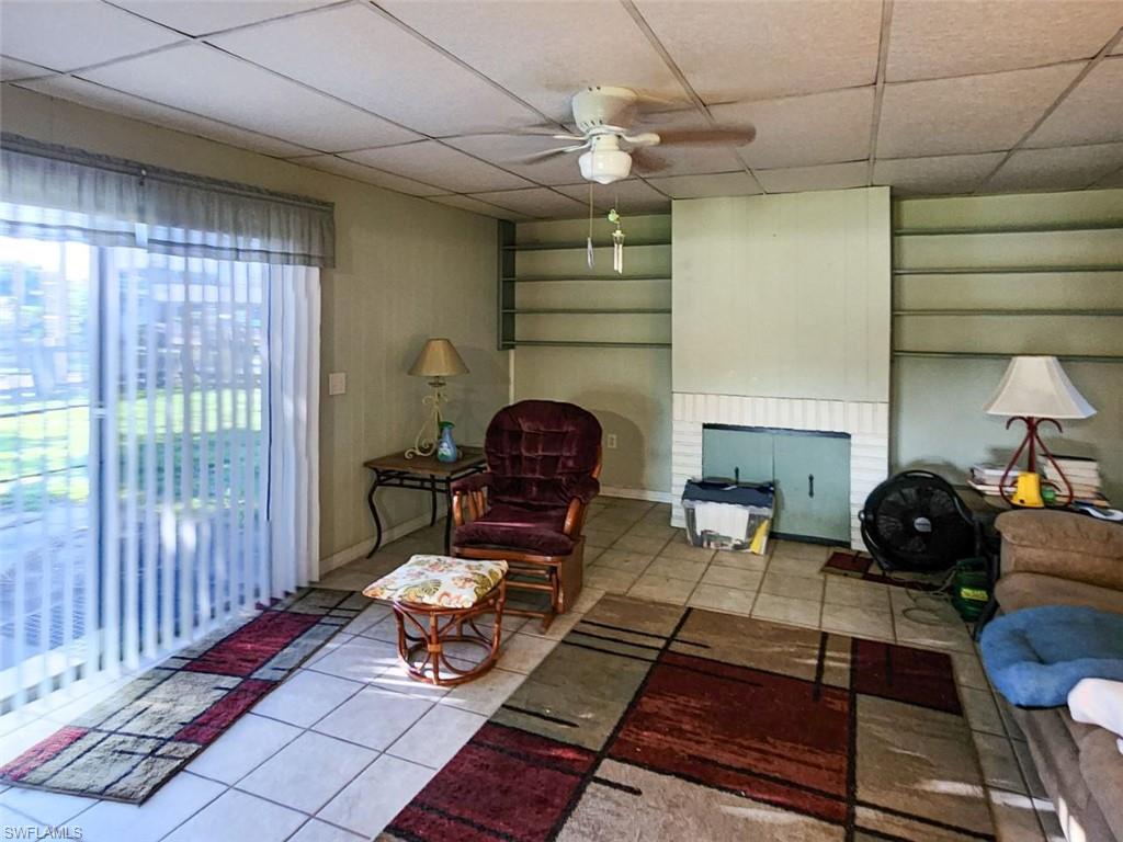 2625 Mohican Drive Melbourne, FL 32935 - Photo 4 of 8 a living room with furniture a chandelier and a large window