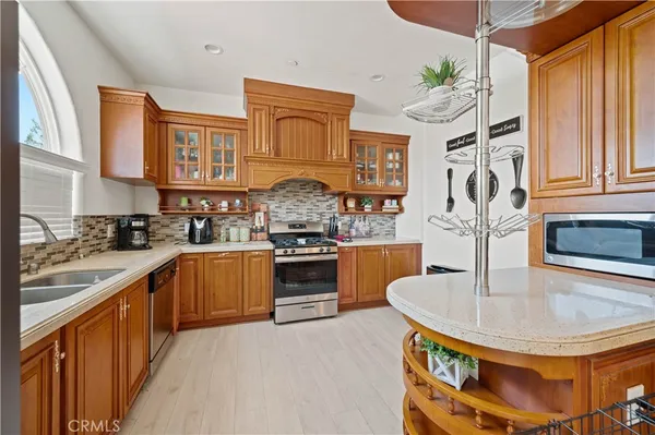 a kitchen with stainless steel appliances a sink a counter space and a view of kitchen