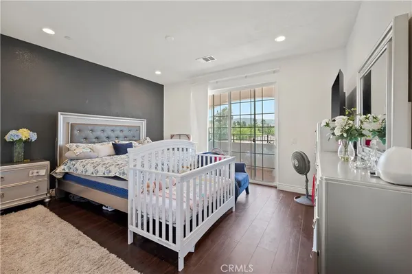 a bedroom with a bed and a couch