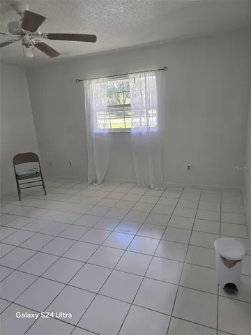 a view of outdoor space with green field and trees