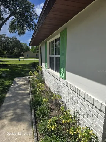 a view of livingroom with furniture and a potted plant