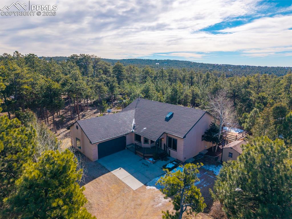 505 Cimarron Road Monument, CO 80132 - Photo 2 of 50 Showing beautiful pines surround the home