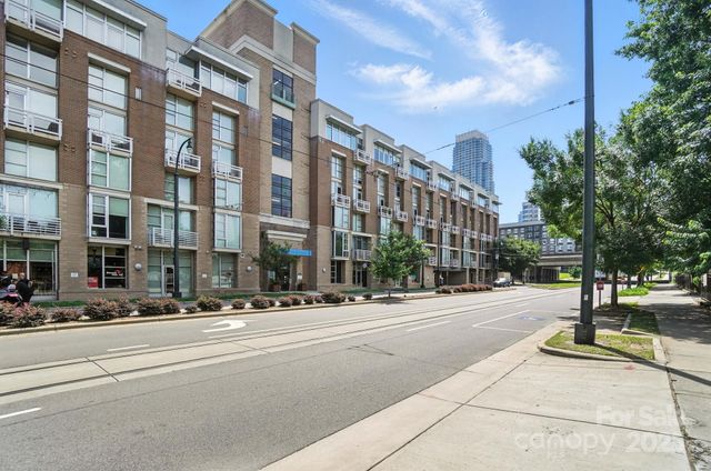 a city street lined with buildings and trees