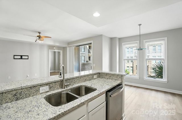 a kitchen with a sink and large window