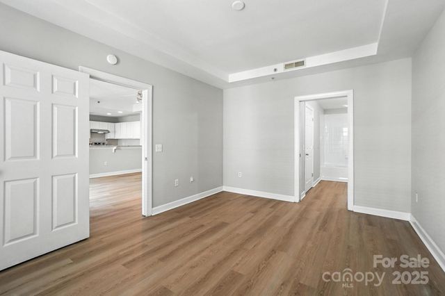 a view of empty room with wooden floor