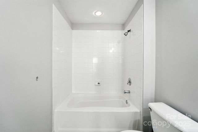 a bathroom with a bathtub and a toilet