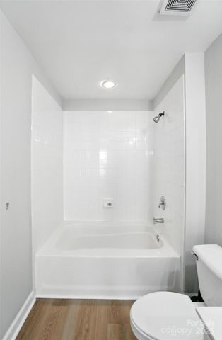a bathroom with a bathtub and a toilet
