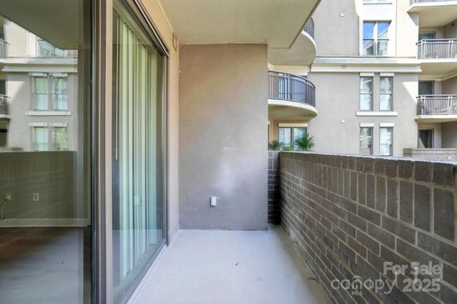 a view of a brick house with many windows