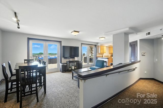 a living room with fireplace furniture and a large window