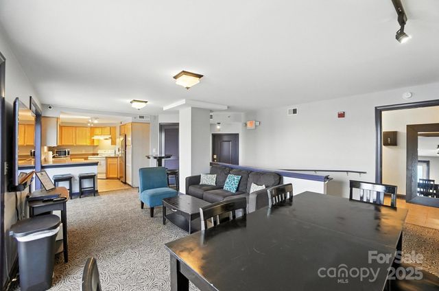 a living room with furniture and a chandelier