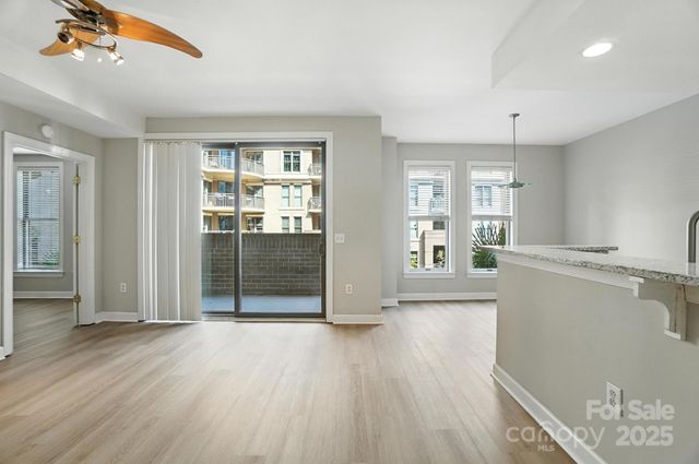 a view of a kitchen with wooden floor and a window