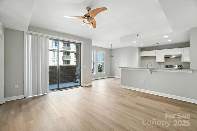 a view of a kitchen with a sink and a refrigerator