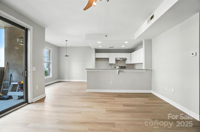 a view of a kitchen with a sink and cabinets
