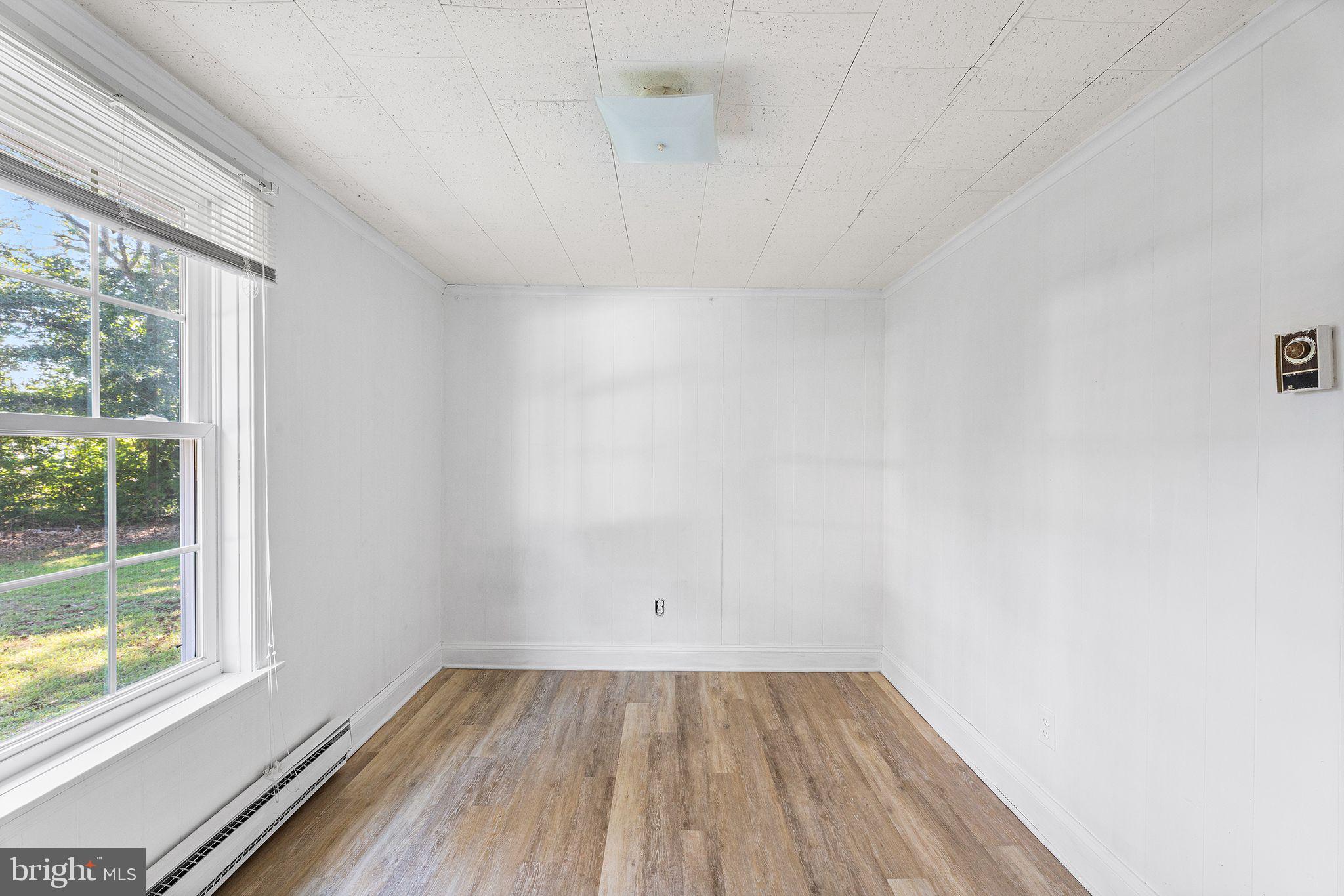 11920 Back Creek Road Bishopville, MD 21813 - Photo 19 of 38 a view of an empty room with wooden floor and a window