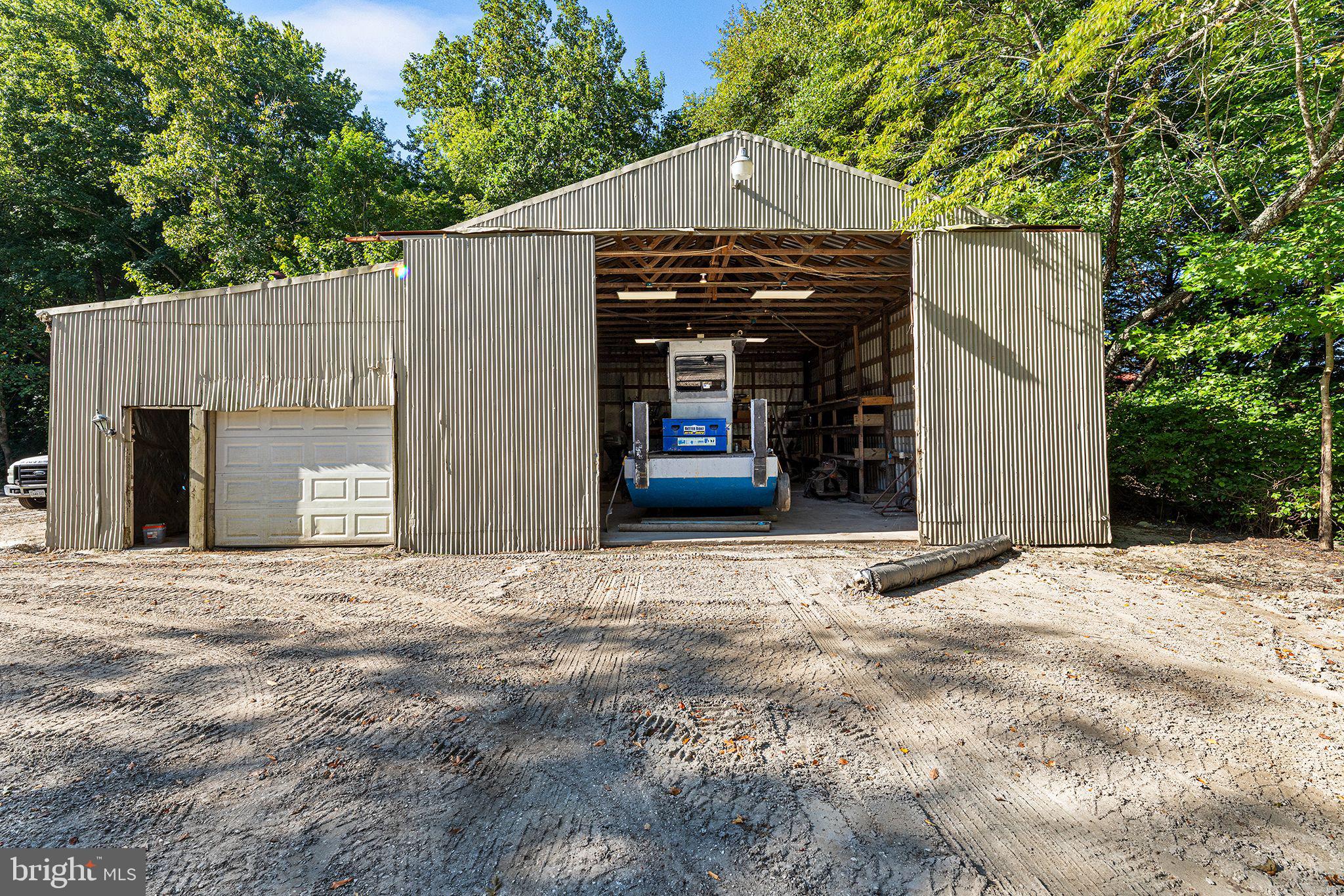 11920 Back Creek Road Bishopville, MD 21813 - Photo 32 of 38 a view of a house with a garage and yard