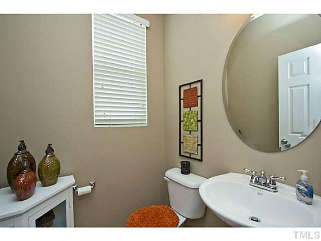 1802 Affirmed Way Cary, NC 27519 - Photo 16 of 24 a bathroom with a toilet sink and mirror