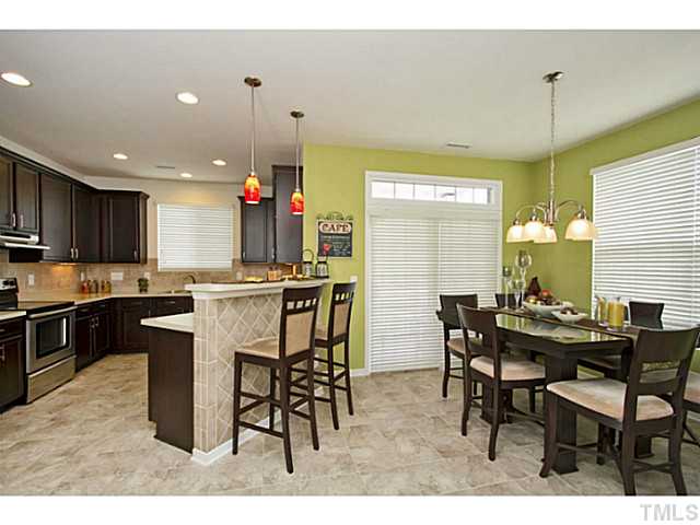 1802 Affirmed Way Cary, NC 27519 - Photo 6 of 24 a kitchen with a table and chairs in it