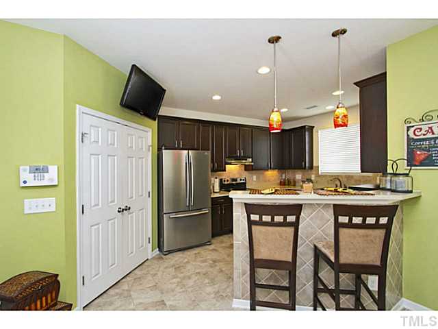 1802 Affirmed Way Cary, NC 27519 - Photo 8 of 24 a kitchen with kitchen island a counter top space appliances and cabinets