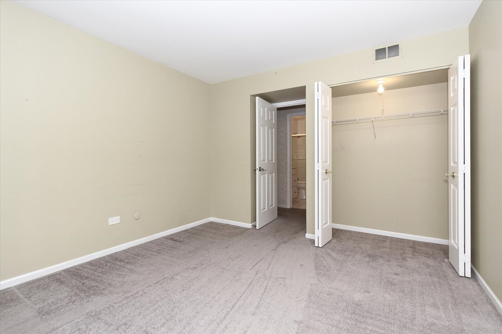 299 Mallard Point, Unit D Lake Barrington, IL 60010 - Photo 14 of 30 an empty room with closet and wooden floor