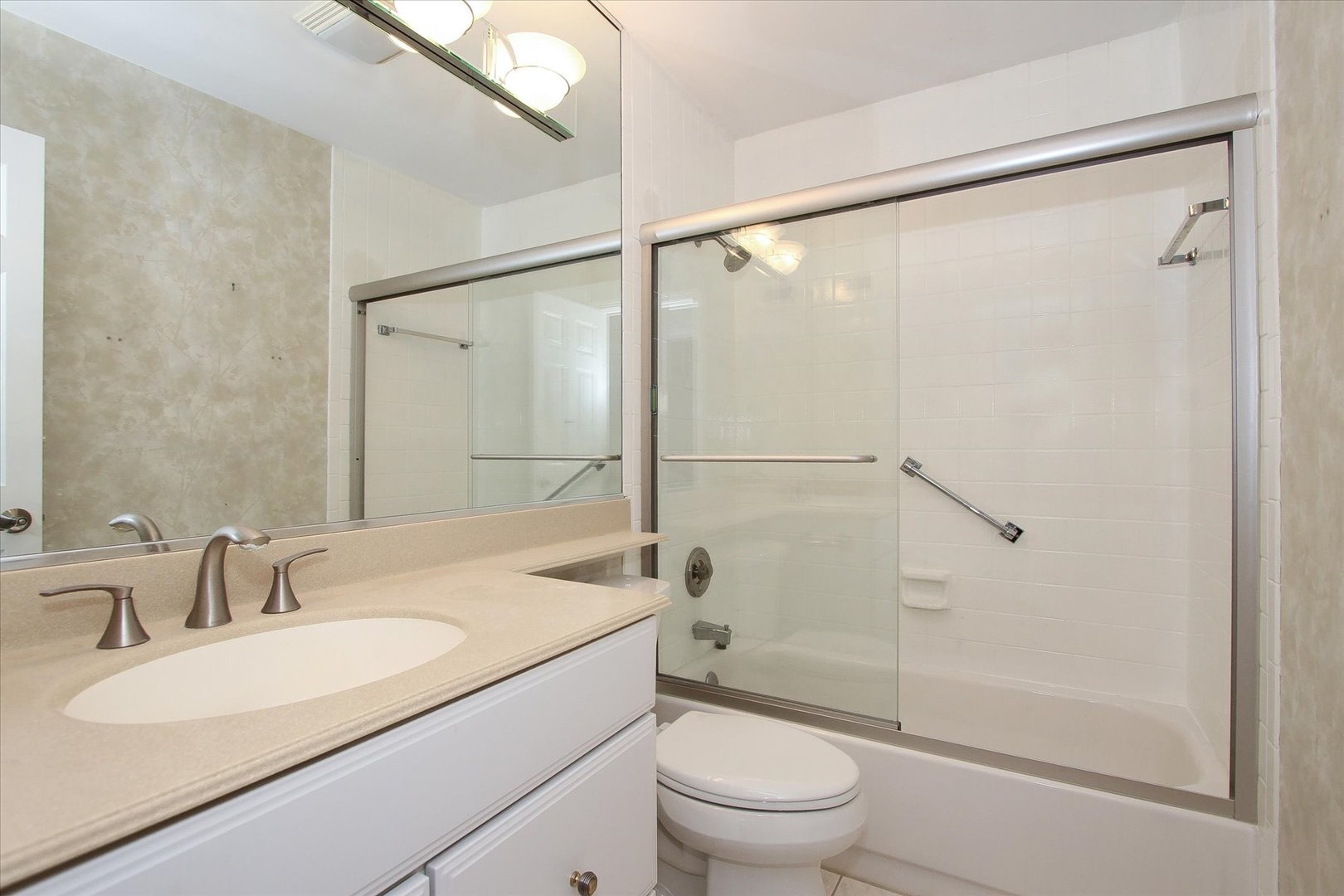 299 Mallard Point, Unit D Lake Barrington, IL 60010 - Photo 15 of 30 a bathroom with a sink toilet and shower