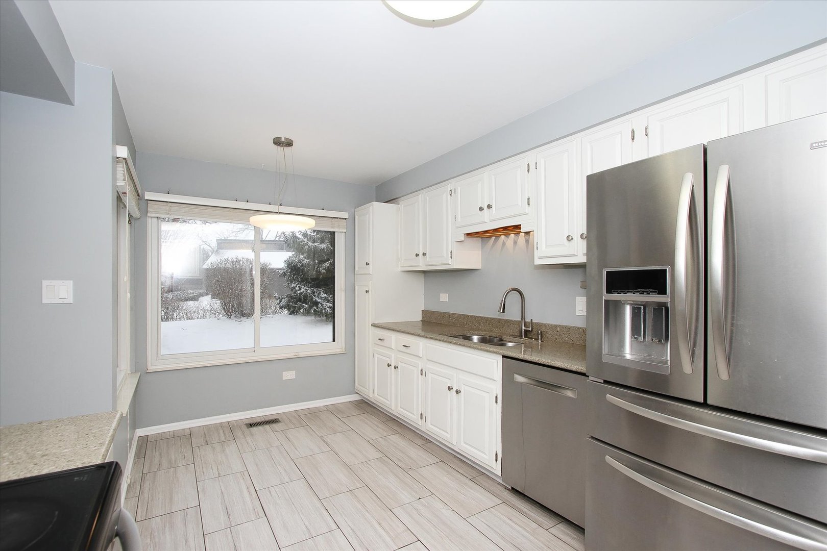 299 Mallard Point, Unit D Lake Barrington, IL 60010 - Photo 7 of 30 a kitchen with granite countertop a refrigerator and a sink