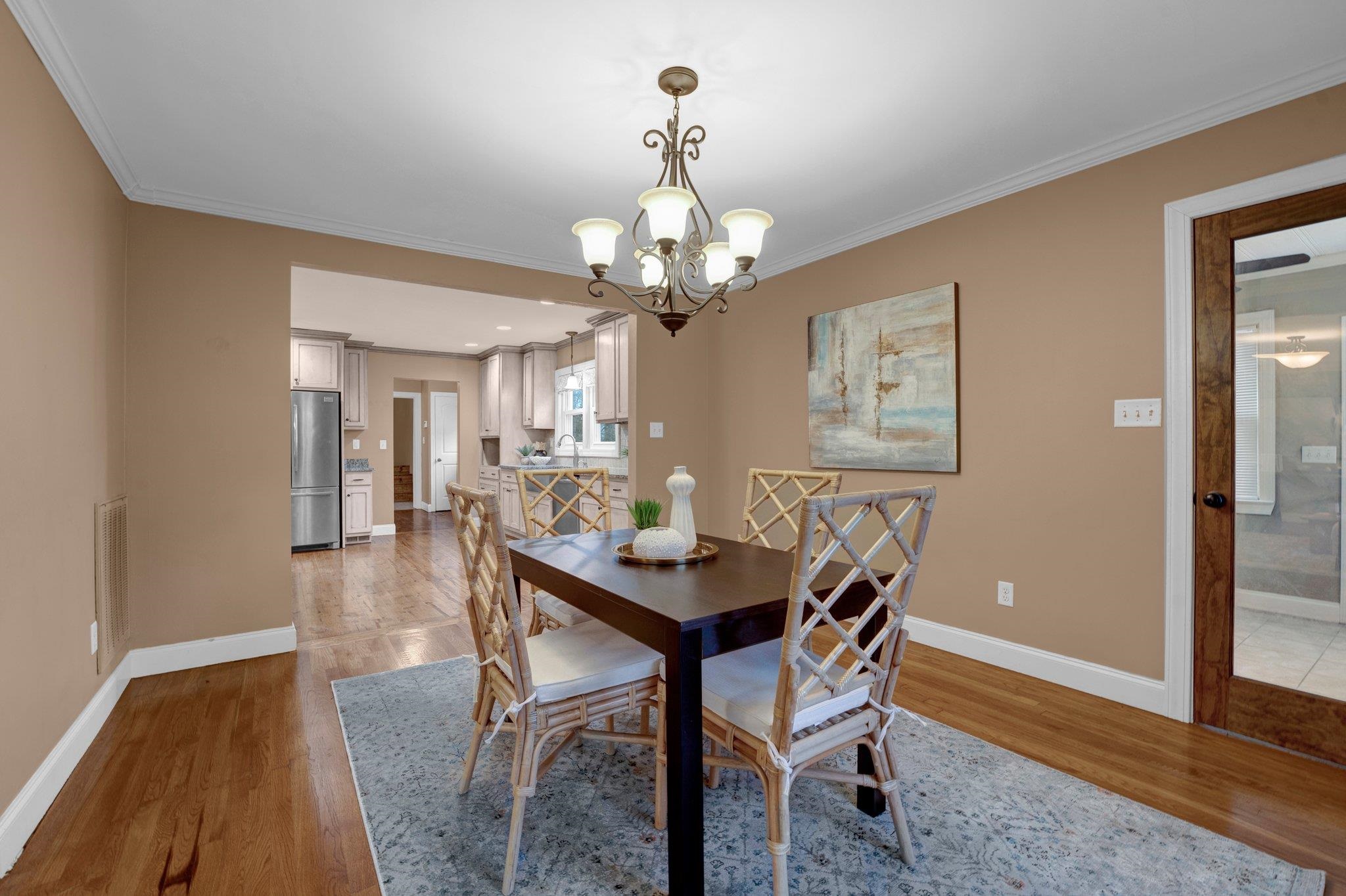 1060 Beaver Creek Road Brighton, TN 38011 - Photo 5 of 40 Dining room featuring a chandelier, crown molding, and wood-type flooring