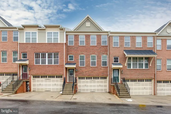 a front view of a building with a yard