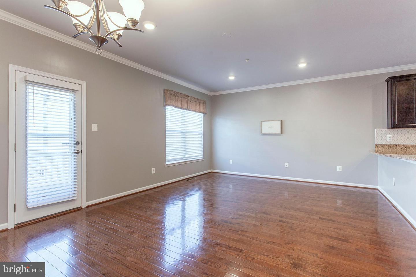 2706 Amber Crest Road Hanover, MD 21076 - Photo 11 of 28 a view of an empty room with wooden floor and a window