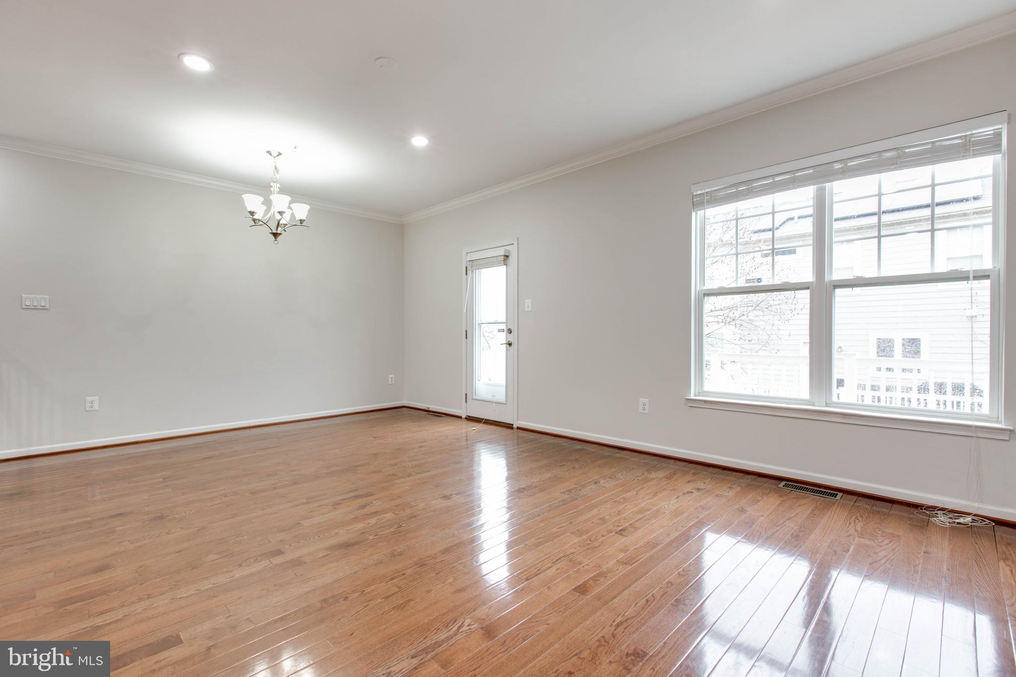 2706 Amber Crest Road Hanover, MD 21076 - Photo 12 of 44 an empty room with wooden floor and windows