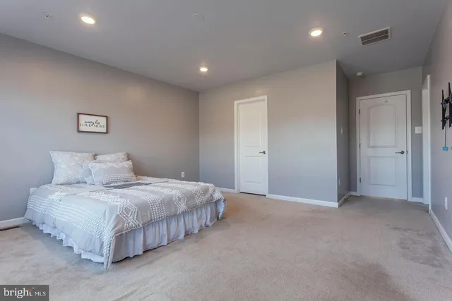 a bedroom with a bed and a night stand