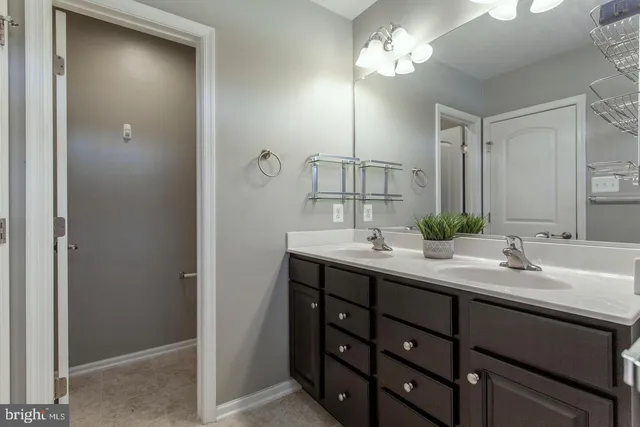 a bathroom with a double vanity sink and a mirror