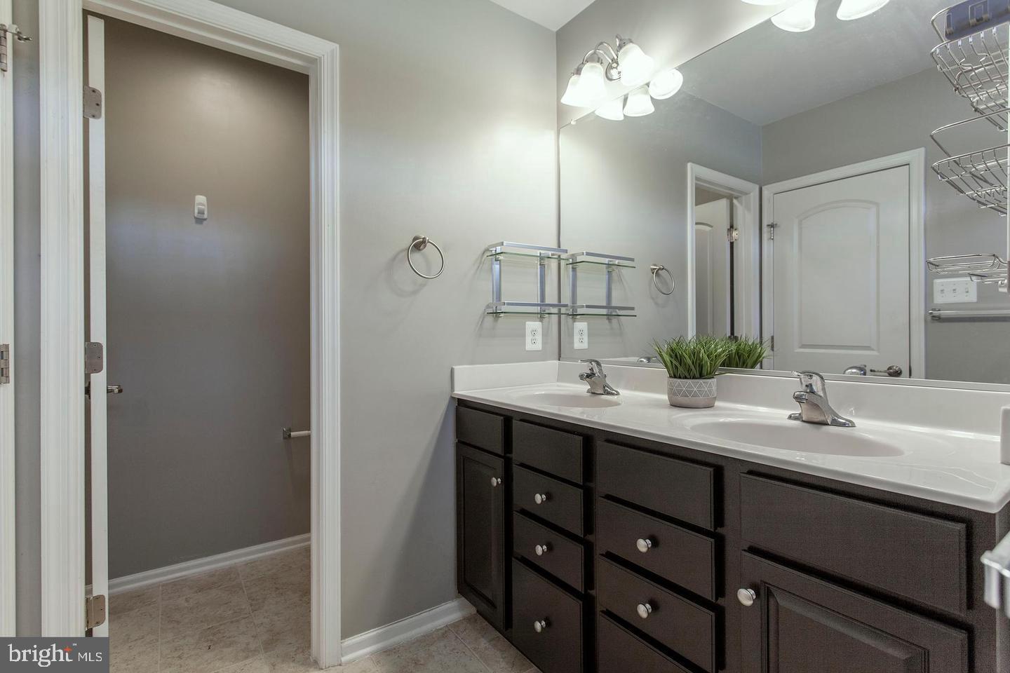 2706 Amber Crest Road Hanover, MD 21076 - Photo 19 of 28 a bathroom with a double vanity sink and a mirror