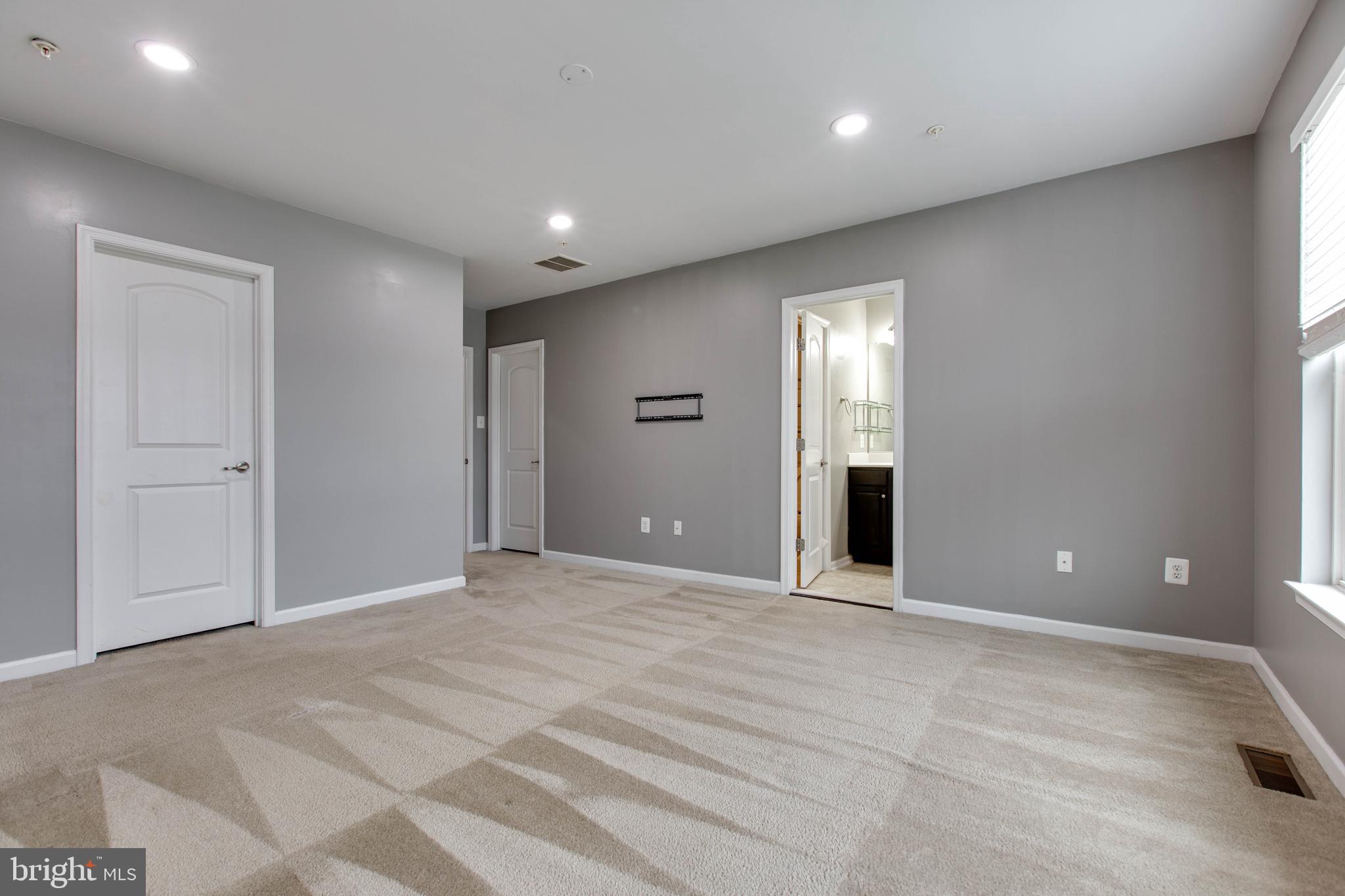 2706 Amber Crest Road Hanover, MD 21076 - Photo 24 of 44 a view of an empty room with wooden floor and windows