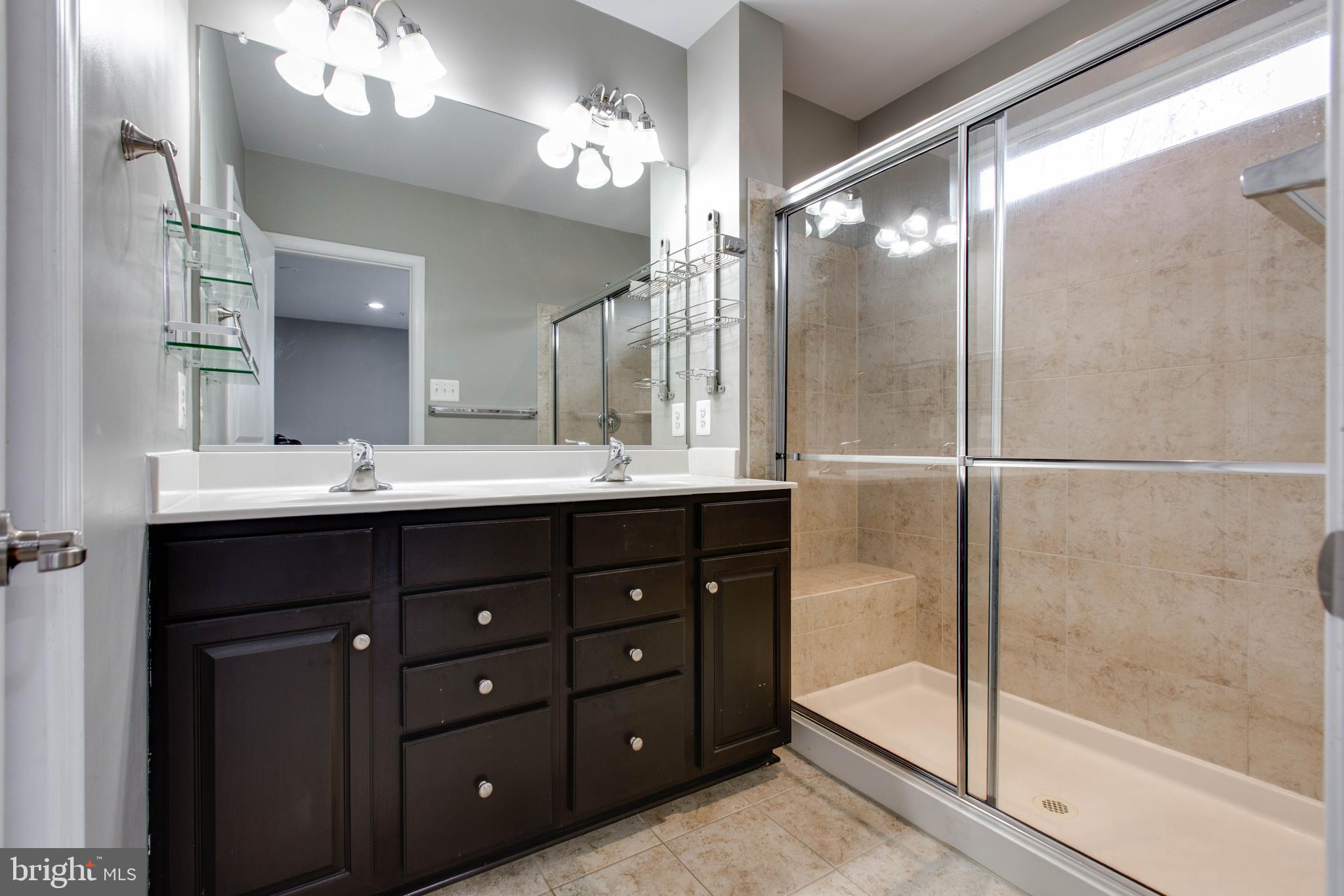 2706 Amber Crest Road Hanover, MD 21076 - Photo 25 of 44 a bathroom with a double vanity sink mirror and shower
