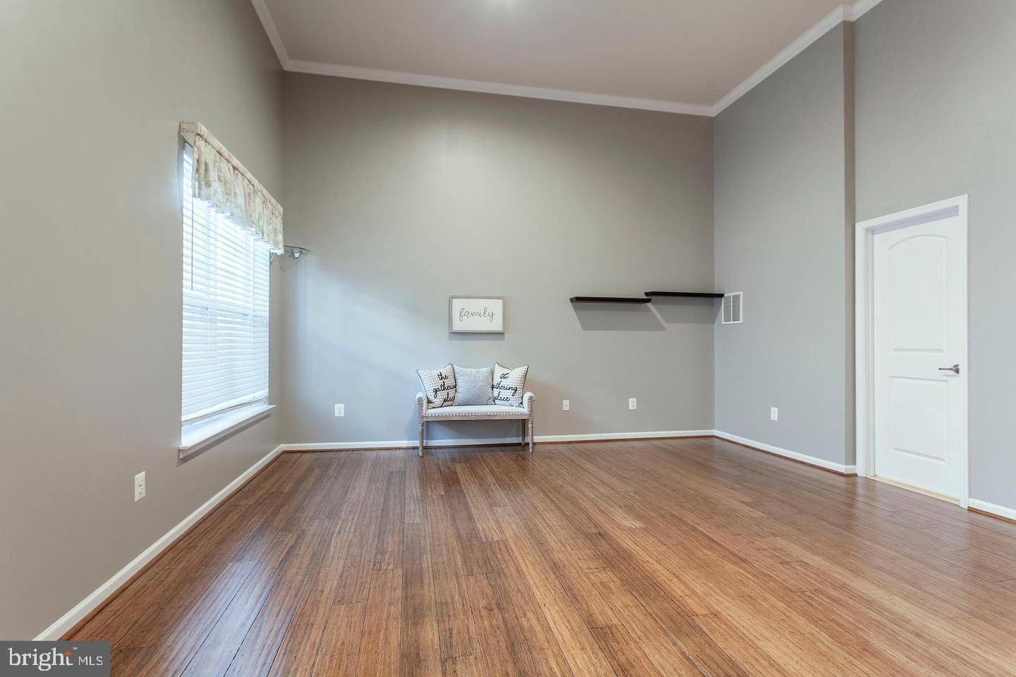 2706 Amber Crest Road Hanover, MD 21076 - Photo 26 of 28 an empty room with wooden floor and windows