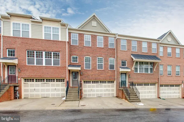 a front view of a house with a parking area