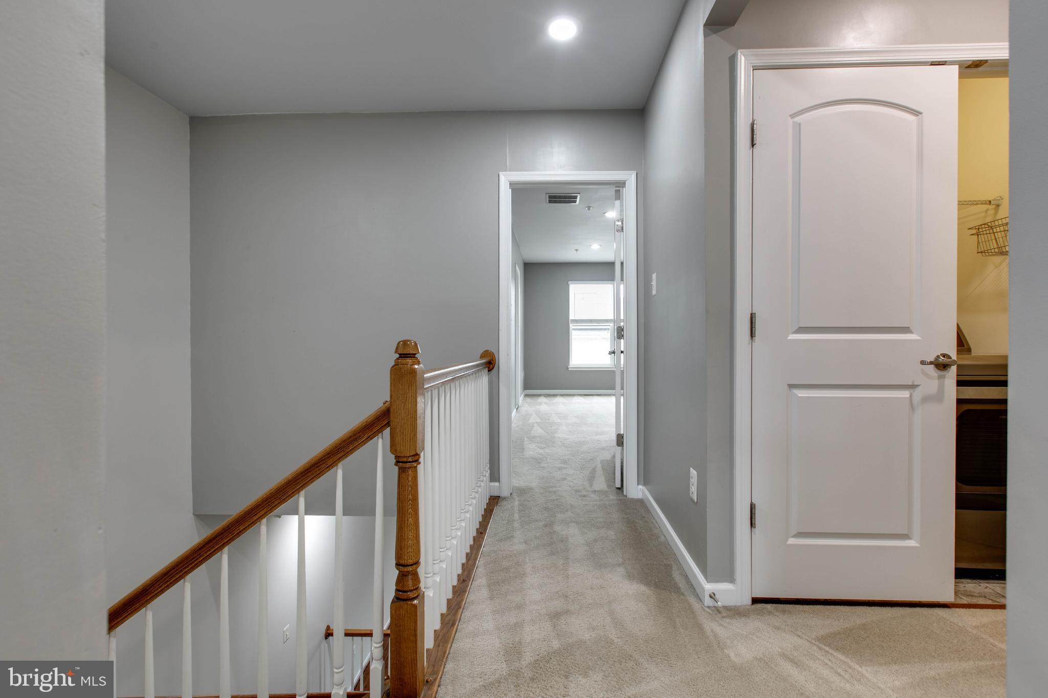 2706 Amber Crest Road Hanover, MD 21076 - Photo 35 of 44 a view of a hallway with wooden floor and entryway