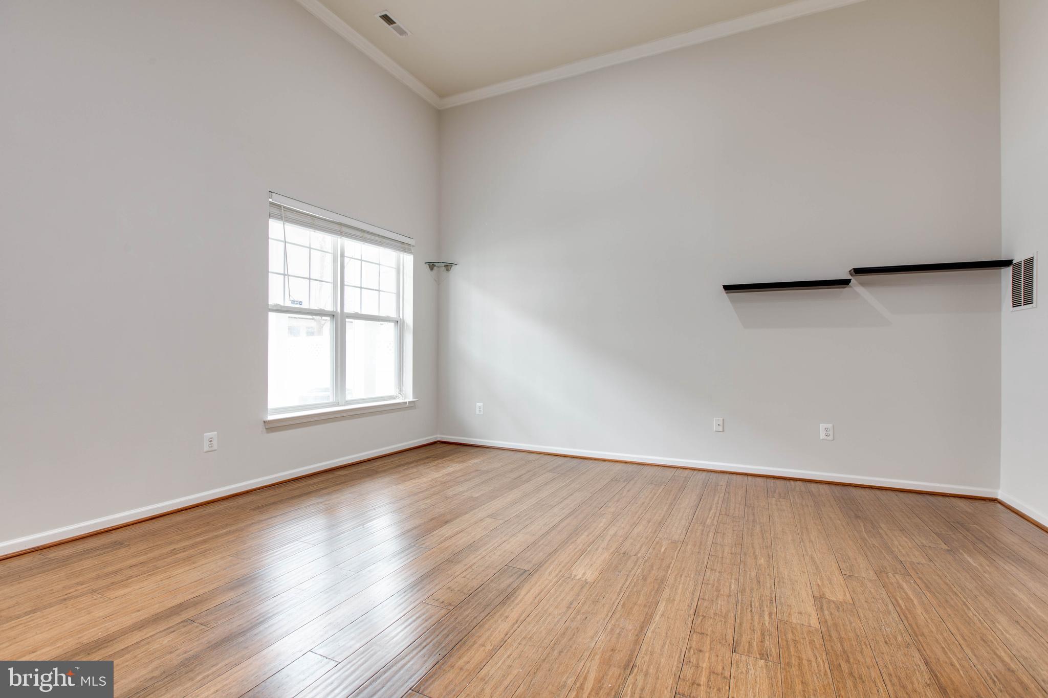 2706 Amber Crest Road Hanover, MD 21076 - Photo 40 of 44 an empty room with wooden floor and windows