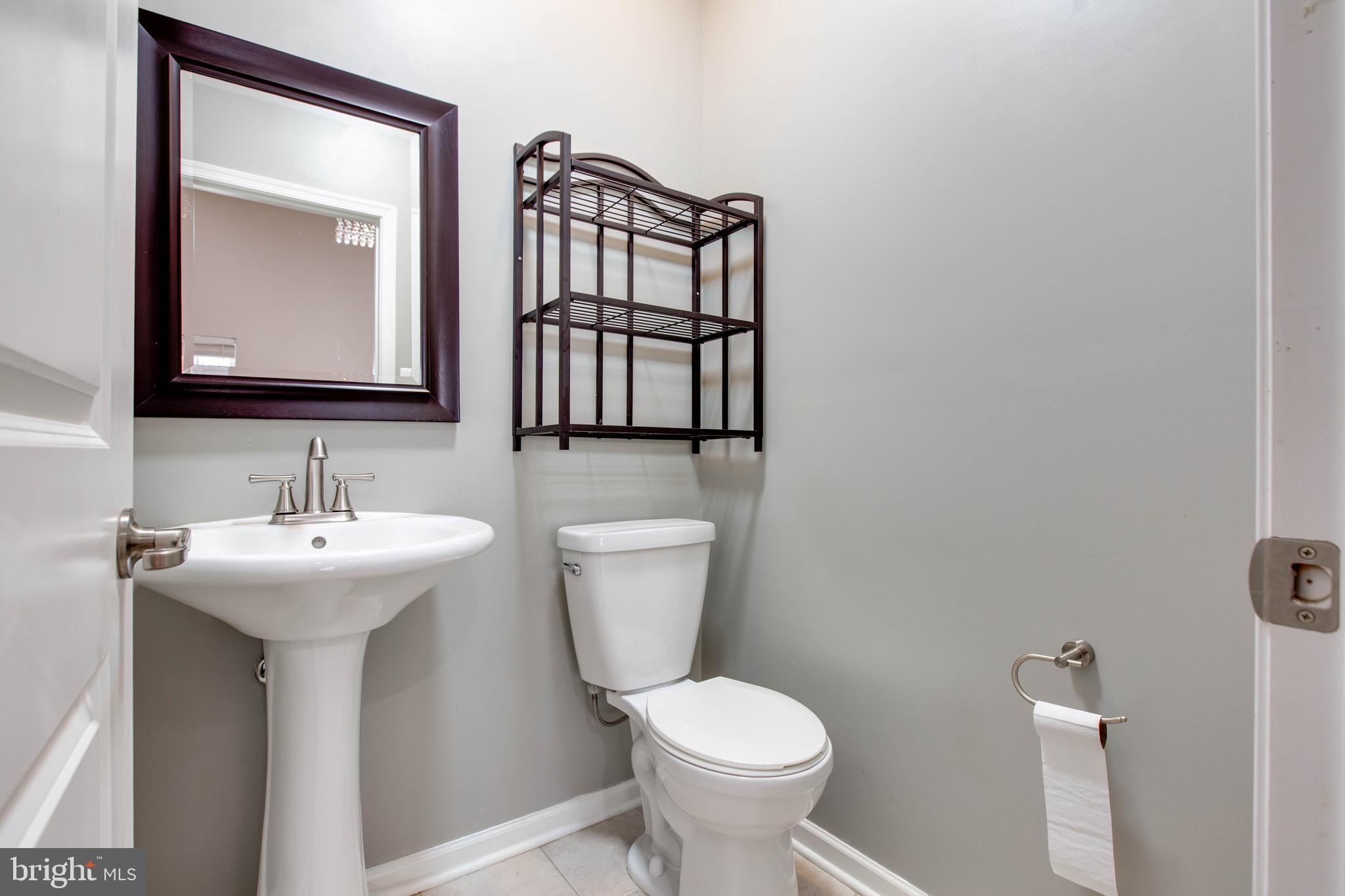 2706 Amber Crest Road Hanover, MD 21076 - Photo 41 of 44 a bathroom with a toilet sink and mirror