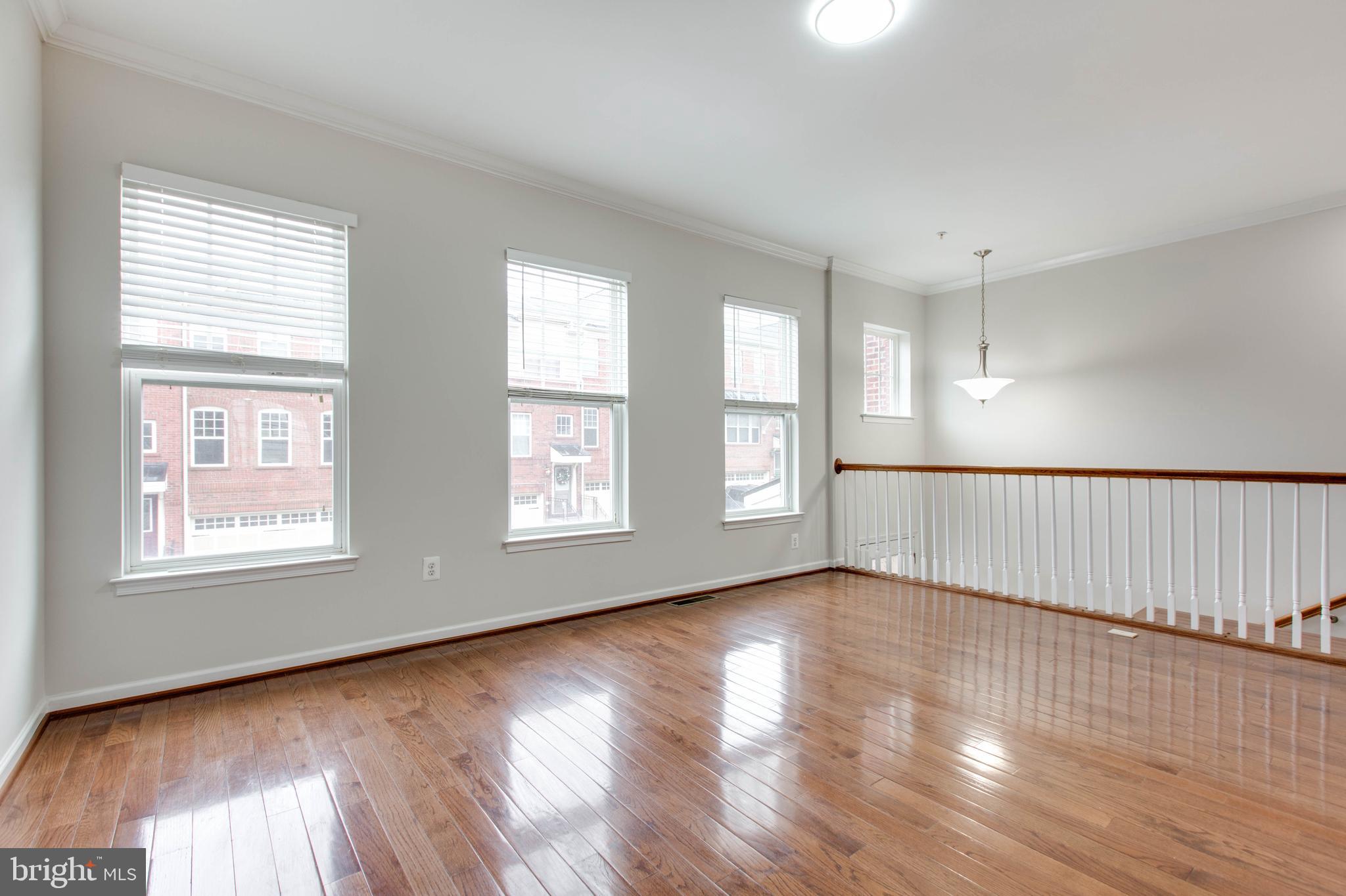 2706 Amber Crest Road Hanover, MD 21076 - Photo 5 of 44 a view of an empty room with wooden floor and a window