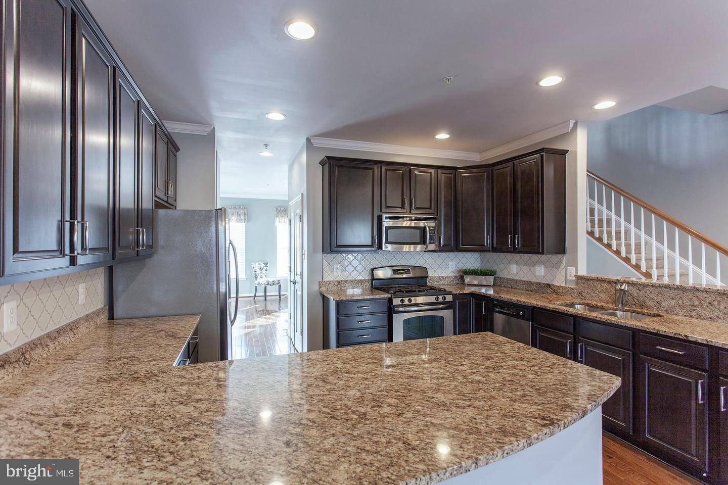 2706 Amber Crest Road Hanover, MD 21076 - Photo 6 of 28 a kitchen with stainless steel appliances granite countertop a sink stove and refrigerator