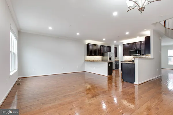 a view of kitchen with refrigerator microwave and wooden floor