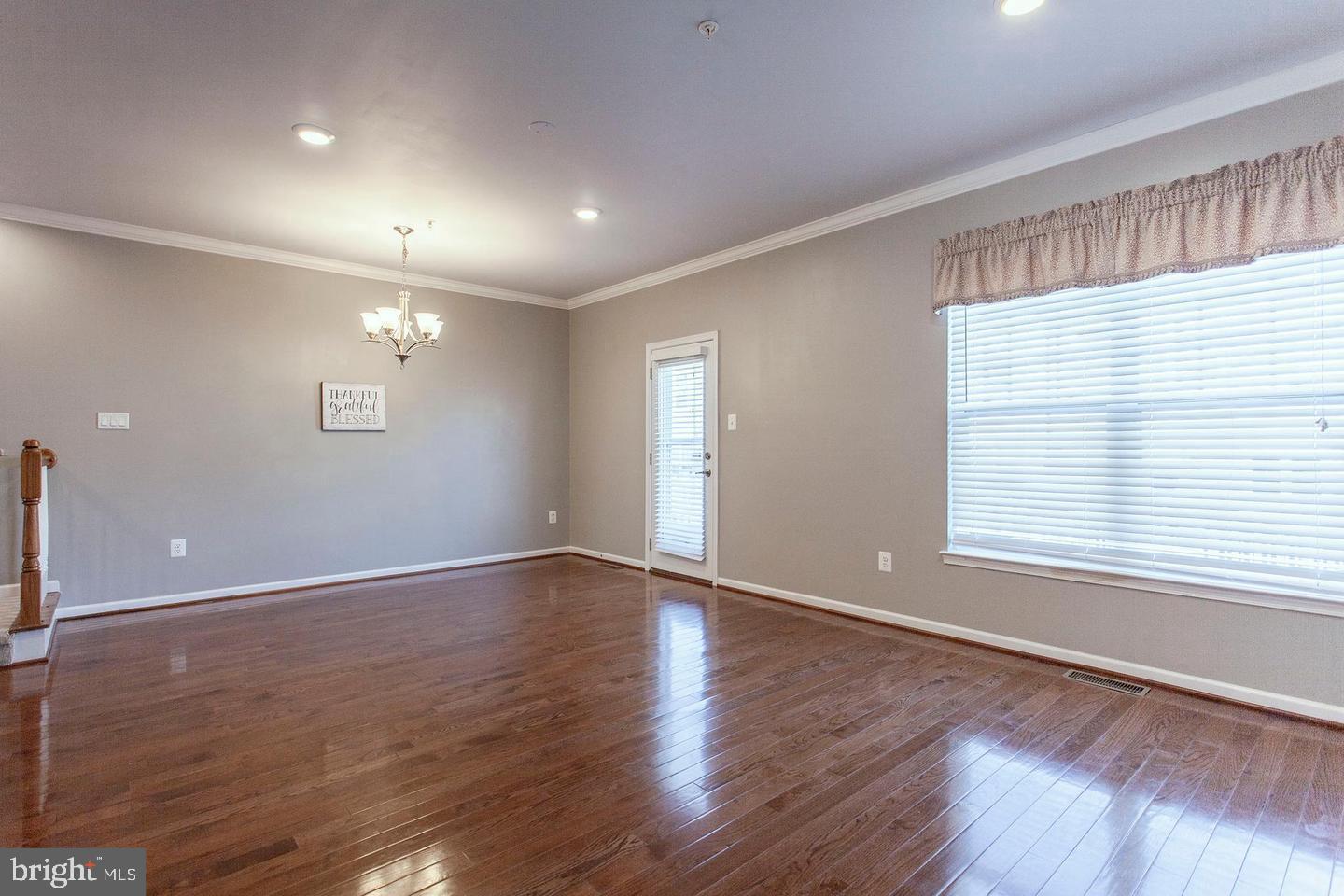2706 Amber Crest Road Hanover, MD 21076 - Photo 10 of 28 a view of an empty room with wooden floor and a window