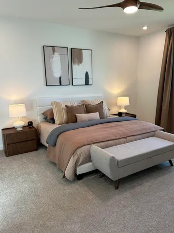 a bedroom with bed and a night stand